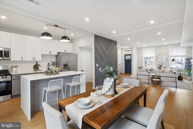 dining area with light hardwood / wood-style flooring