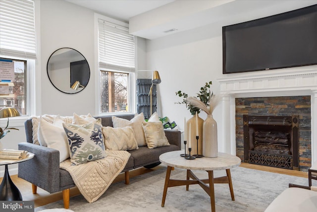 living room featuring a stone fireplace