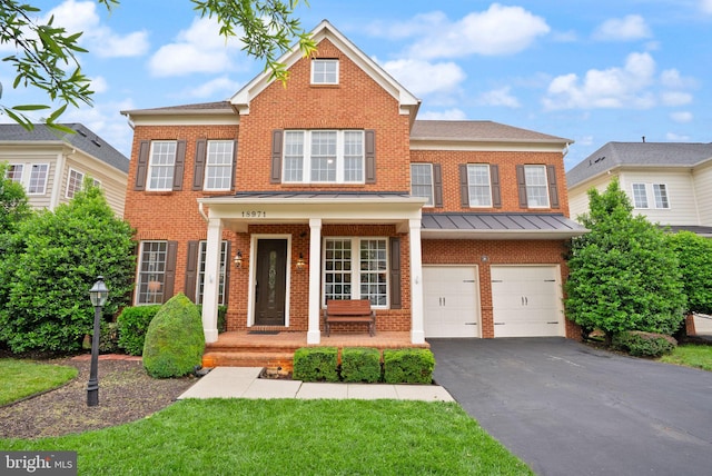 18971 Kipheart Dr, Leesburg, VA 20176 - colonial home with brick siding, driveway, a garage, and covered porch