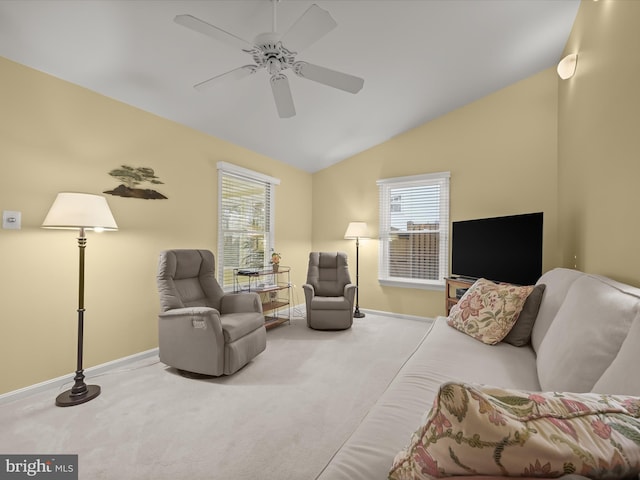 carpeted living room featuring a healthy amount of sunlight, baseboards, lofted ceiling, and ceiling fan