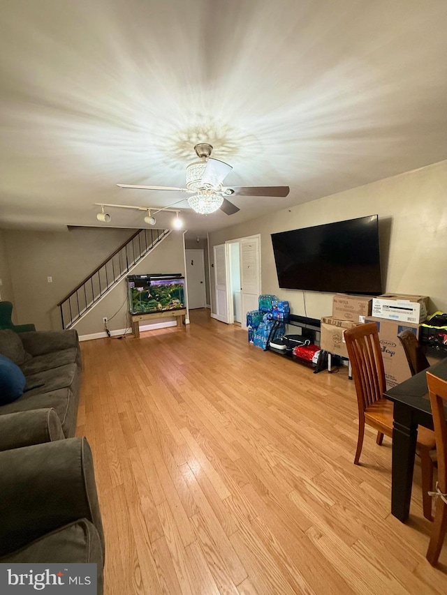 living room with ceiling fan and light wood-type flooring