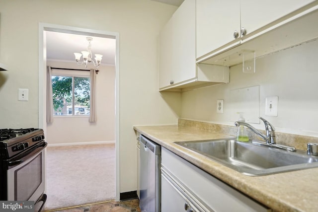 kitchen featuring pendant lighting, white cabinetry, sink, carpet flooring, and stainless steel appliances