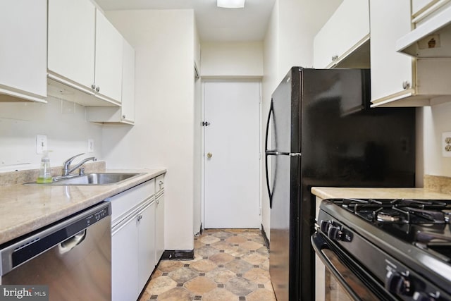 kitchen featuring black fridge, dishwasher, sink, and white cabinets