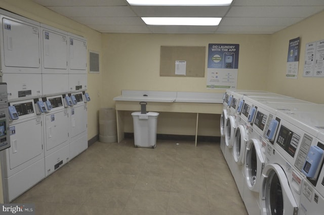 clothes washing area with stacked washer and clothes dryer, light tile patterned floors, and independent washer and dryer