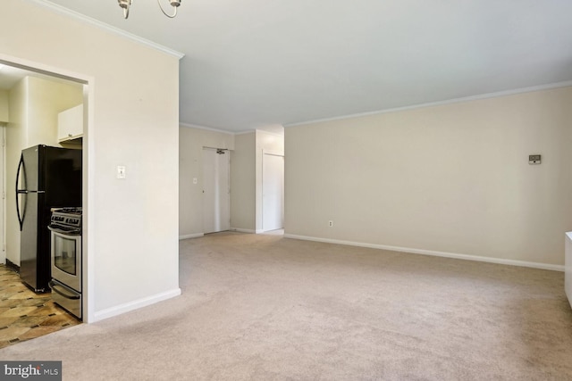 carpeted spare room featuring crown molding