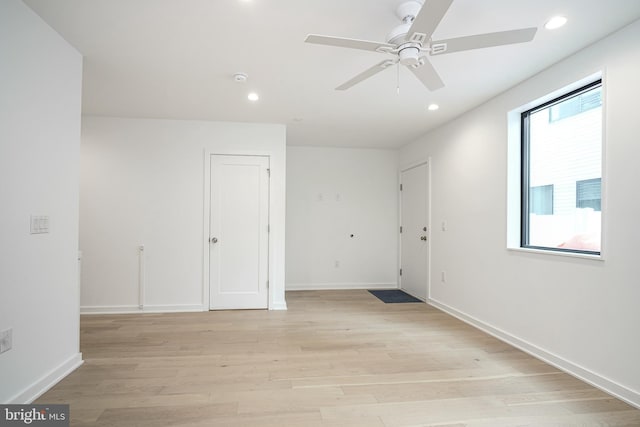 unfurnished room featuring light hardwood / wood-style flooring and ceiling fan