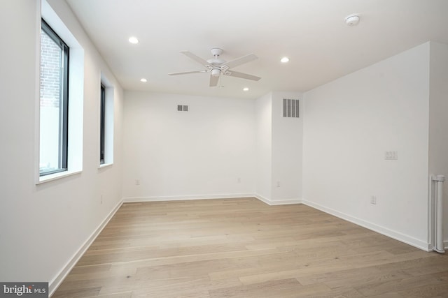 spare room with ceiling fan and light hardwood / wood-style flooring