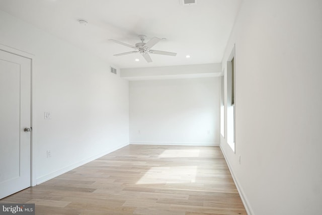 empty room with ceiling fan and light wood-type flooring