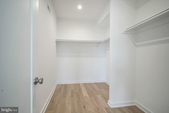 spacious closet with light hardwood / wood-style floors