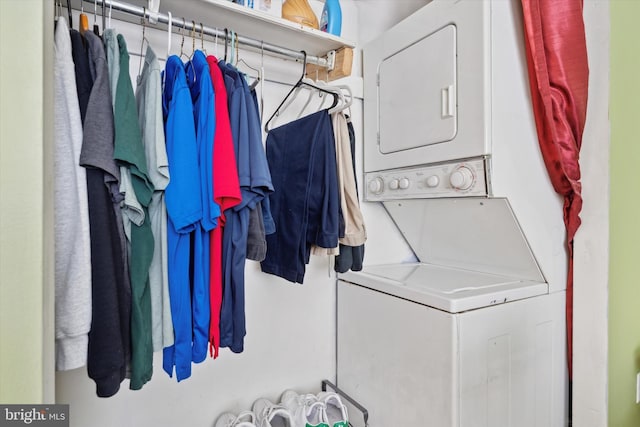 laundry room with stacked washing maching and dryer