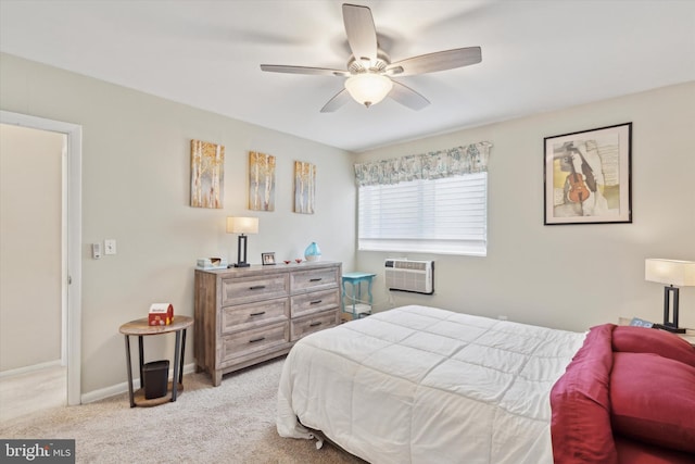 carpeted bedroom with ceiling fan and a wall mounted AC