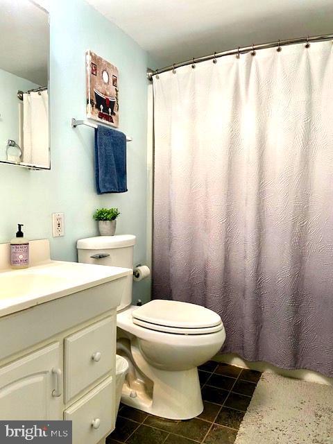 bathroom with vanity, tile patterned flooring, and toilet