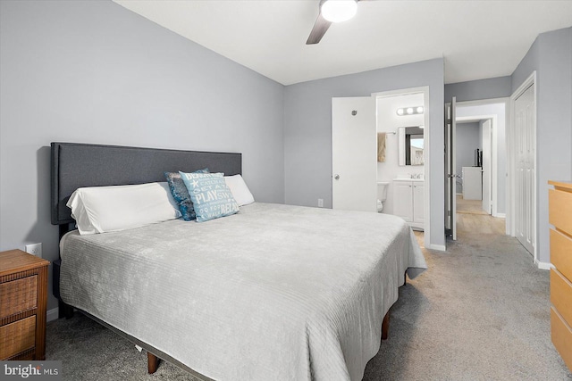 bedroom with ceiling fan, light colored carpet, connected bathroom, and sink