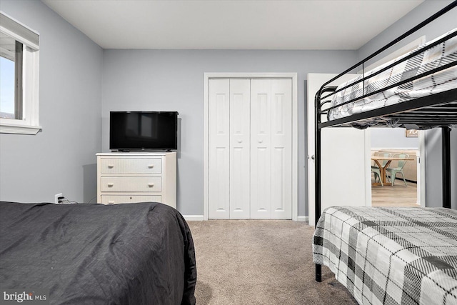 carpeted bedroom featuring a closet