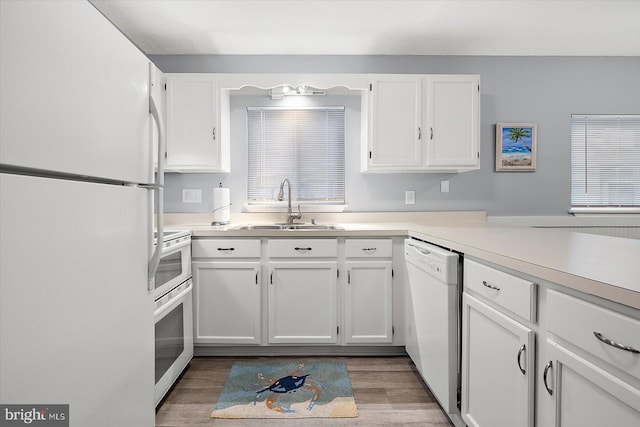 kitchen with white cabinetry, white appliances, dark hardwood / wood-style floors, and sink