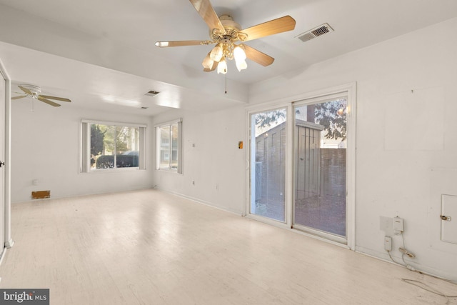 spare room with ceiling fan and light wood-type flooring