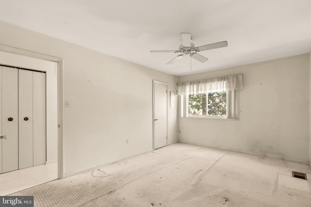 unfurnished bedroom featuring ceiling fan