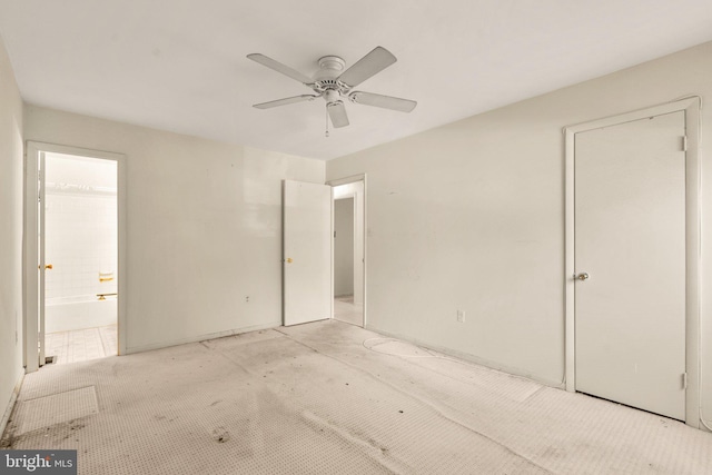 unfurnished bedroom featuring connected bathroom and ceiling fan