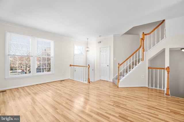 interior space with crown molding and light wood-type flooring