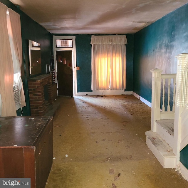 unfurnished living room featuring cooling unit and a fireplace