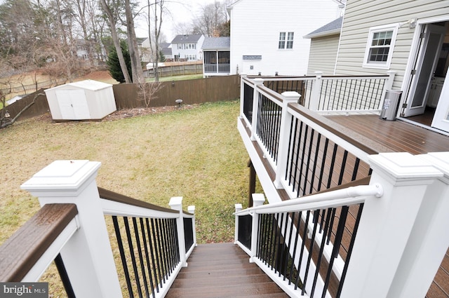 view of yard featuring a storage shed and a deck