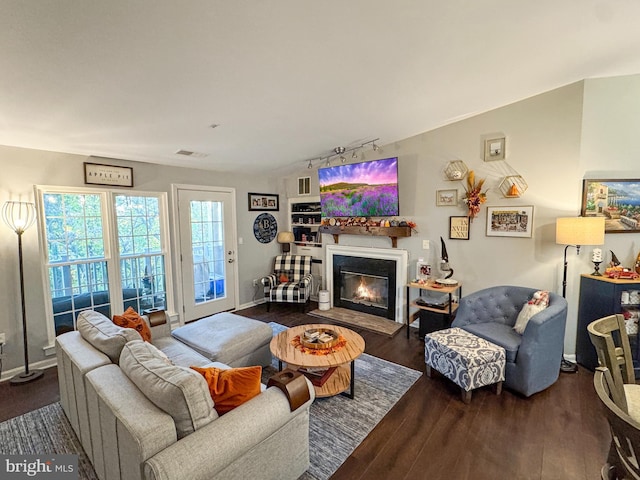 living room with hardwood / wood-style floors and track lighting