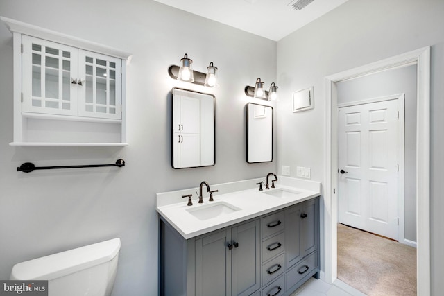 bathroom featuring toilet and vanity