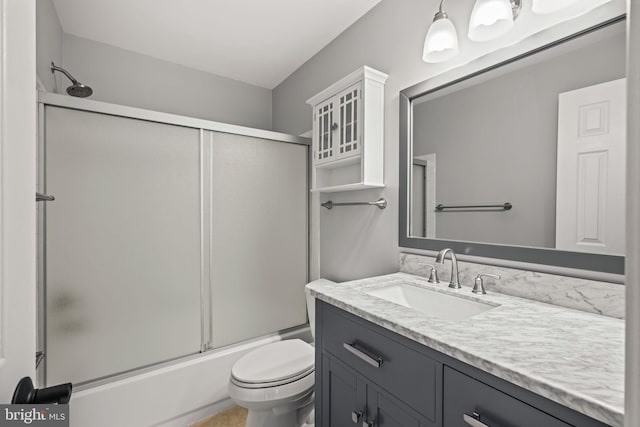 full bathroom featuring toilet, vanity, and combined bath / shower with glass door