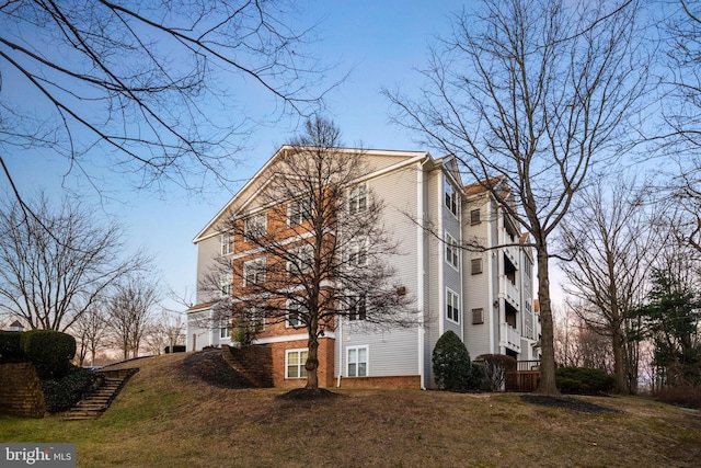 view of side of property featuring a yard