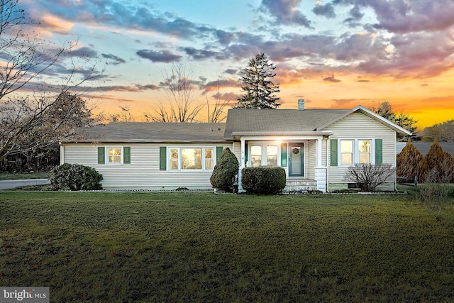 ranch-style house featuring a yard