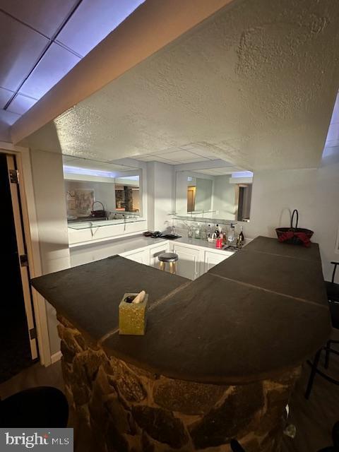 kitchen featuring a textured ceiling and kitchen peninsula