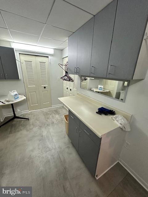 kitchen featuring gray cabinetry and a paneled ceiling