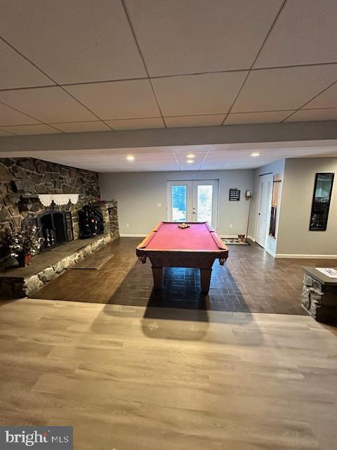 rec room featuring hardwood / wood-style flooring, billiards, french doors, and a drop ceiling