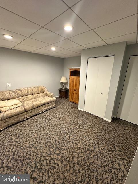 unfurnished bedroom with carpet flooring and a drop ceiling