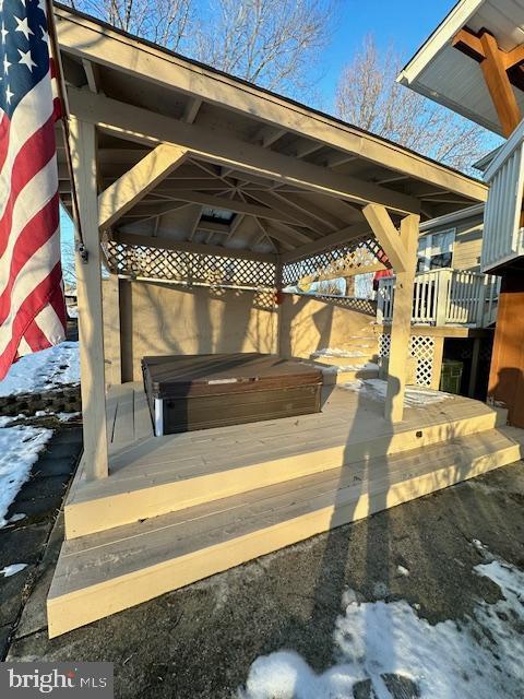 snow covered patio with a deck