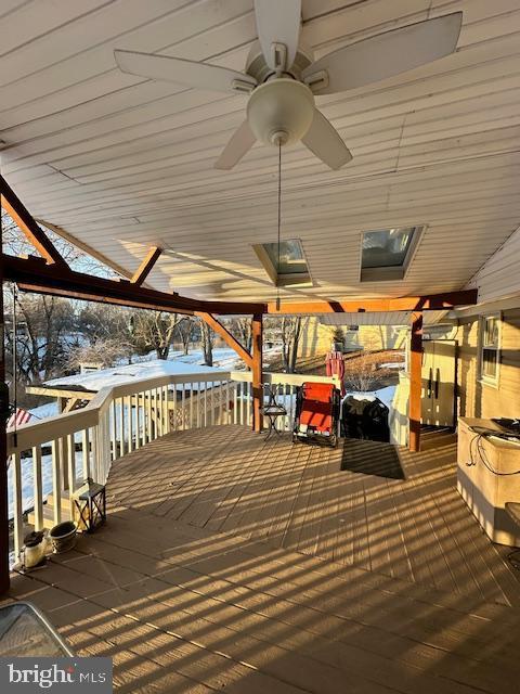 snow covered deck featuring ceiling fan