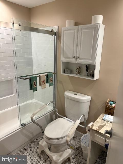 full bathroom with vanity, tile patterned floors, toilet, and combined bath / shower with glass door