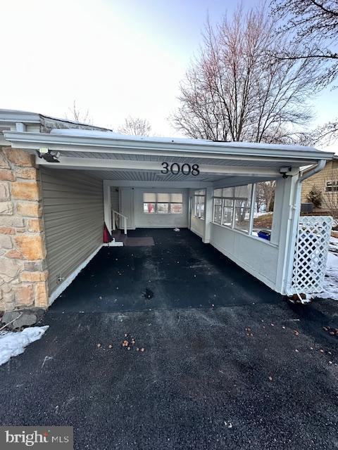 view of parking / parking lot featuring a carport