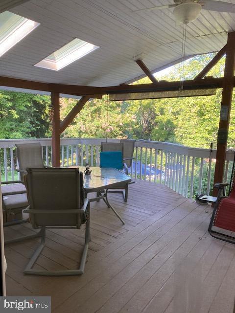 wooden deck featuring ceiling fan