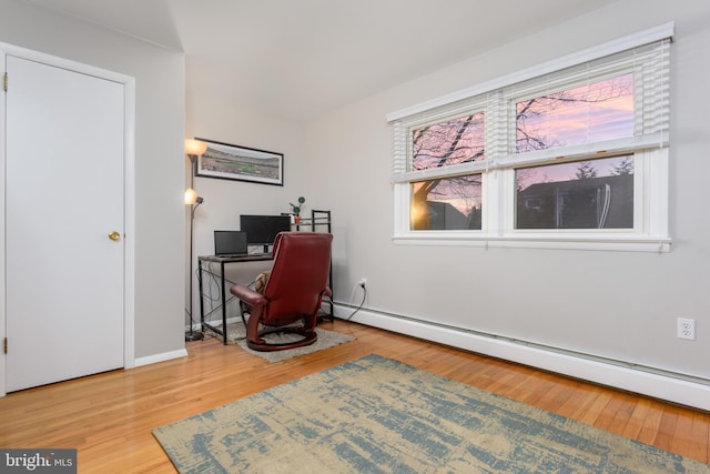 home office with hardwood / wood-style flooring and baseboard heating