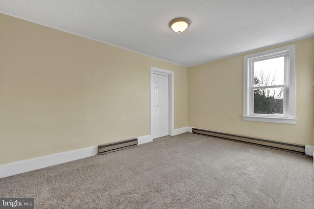 unfurnished room featuring baseboard heating and carpet