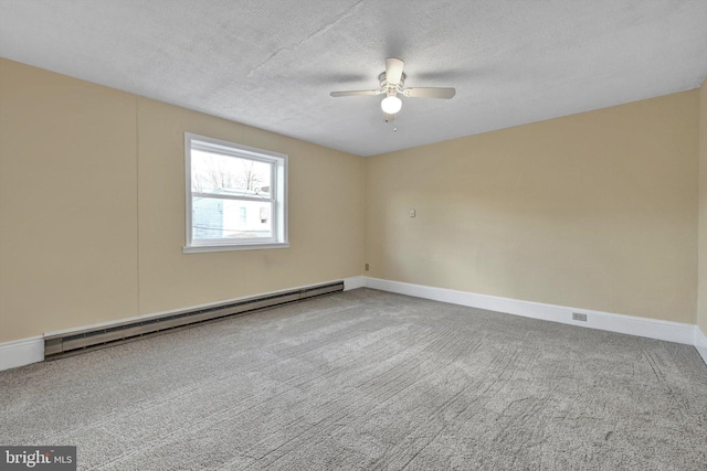 carpeted spare room with ceiling fan, a textured ceiling, and baseboard heating