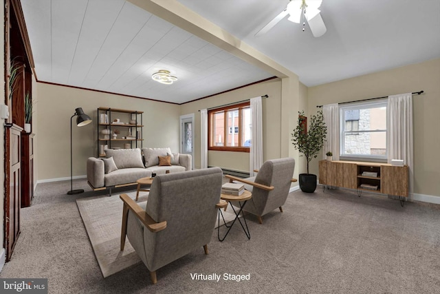 carpeted living room featuring crown molding and ceiling fan