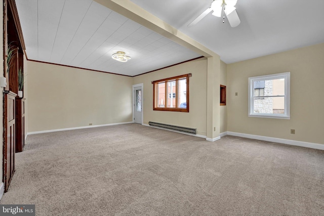 empty room with plenty of natural light, a baseboard heating unit, and light carpet