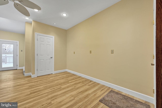 empty room with ceiling fan and light wood-type flooring