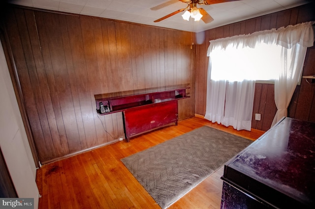 bedroom featuring wooden walls and wood finished floors