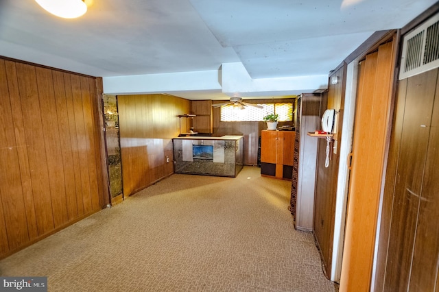 interior space featuring carpet flooring and wooden walls