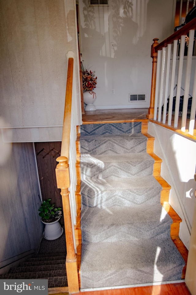 stairway featuring visible vents