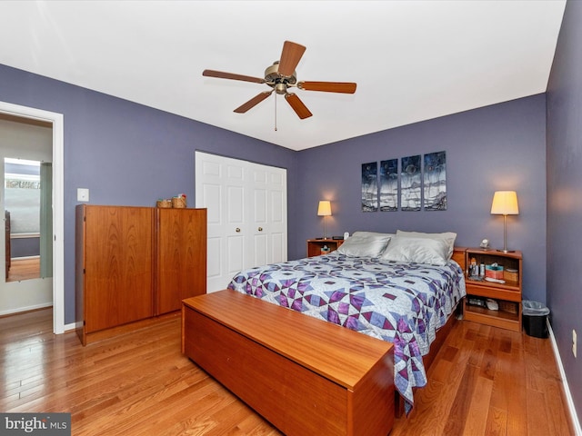 bedroom featuring ceiling fan, a closet, and light hardwood / wood-style flooring