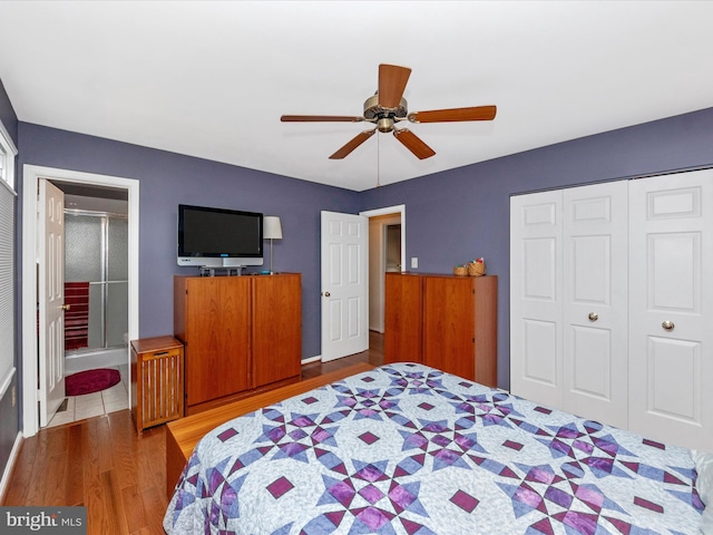 bedroom with ensuite bath, wood-type flooring, a closet, and ceiling fan